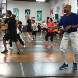 A group of people engaged in footwork drills